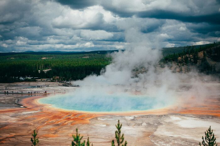 Steam rising from the colorful hot spring in Yellowstone, illustrating disturbing science facts about geothermal activity.