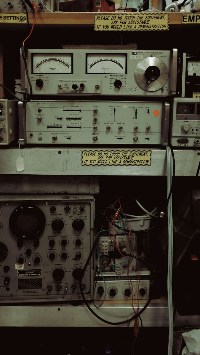 Old electronic test equipment with dials and wires in a cluttered lab setting showing infuriating moments at work.
