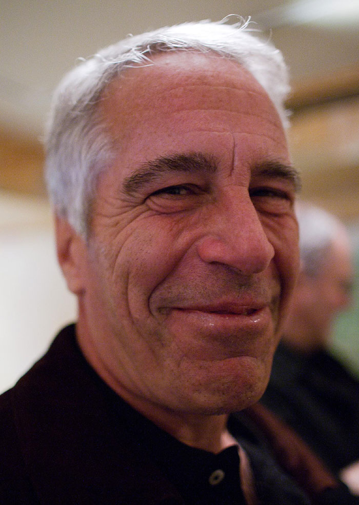 Close-up of a man with gray hair smiling softly in an indoor setting, related to Epstein files and photos of women. Close-up of a man with gray hair smiling softly in an indoor setting, related to Epstein files and photos of women.