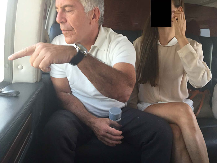 Man in white shirt pointing inside a private plane, with woman sitting beside him partially covering her face in Epstein files photos. Man in white shirt pointing inside a private plane, with woman sitting beside him partially covering her face in Epstein files photos.