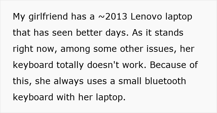 Old Lenovo laptop with broken keyboard, showing a user relying on a spare Bluetooth keyboard for typing.