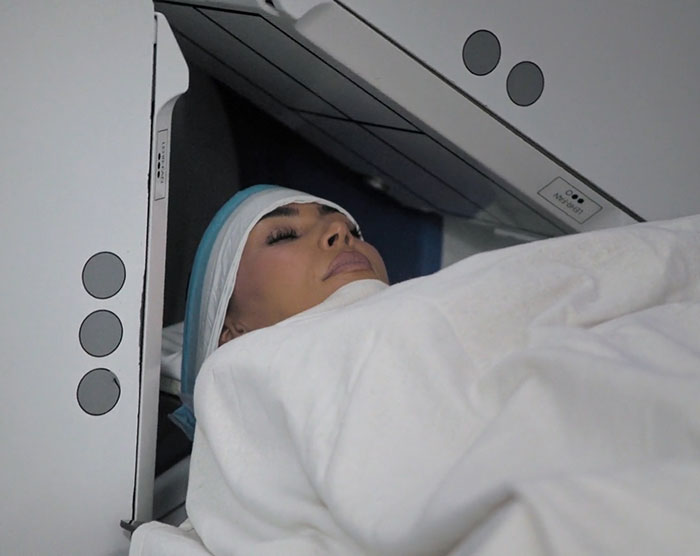 Kim Kardashian undergoing a medical brain scan, wrapped in a white blanket, focusing on brain activity analysis. Kim Kardashian undergoing a medical brain scan, wrapped in a white blanket, focusing on brain activity analysis.
