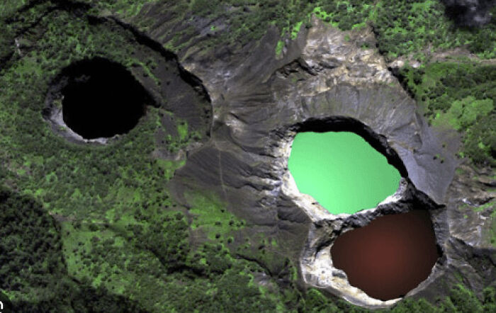 Aerial view of natural crater lakes surrounded by lush greenery in places that look AI generated but are actually real.