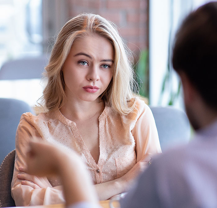 Young woman with arms crossed, showing a rude attitude, representing millennial women in the post-Karen era conversation. Young woman with arms crossed, showing a rude attitude, representing millennial women in the post-Karen era conversation.