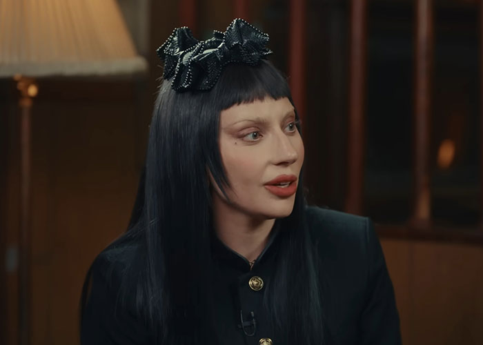Person with black hair and a decorative headband speaking in an indoor interview about meeting famous people.