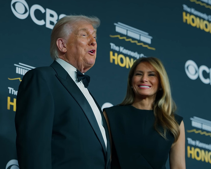 Donald Trump and Melania Trump posing together at a formal event, relating to Christmas card backlash online.