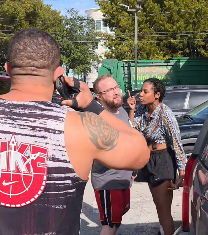 Woman arguing with a man outside a gym in Miami as another man films the confrontation before her arrest for punching an employee.
