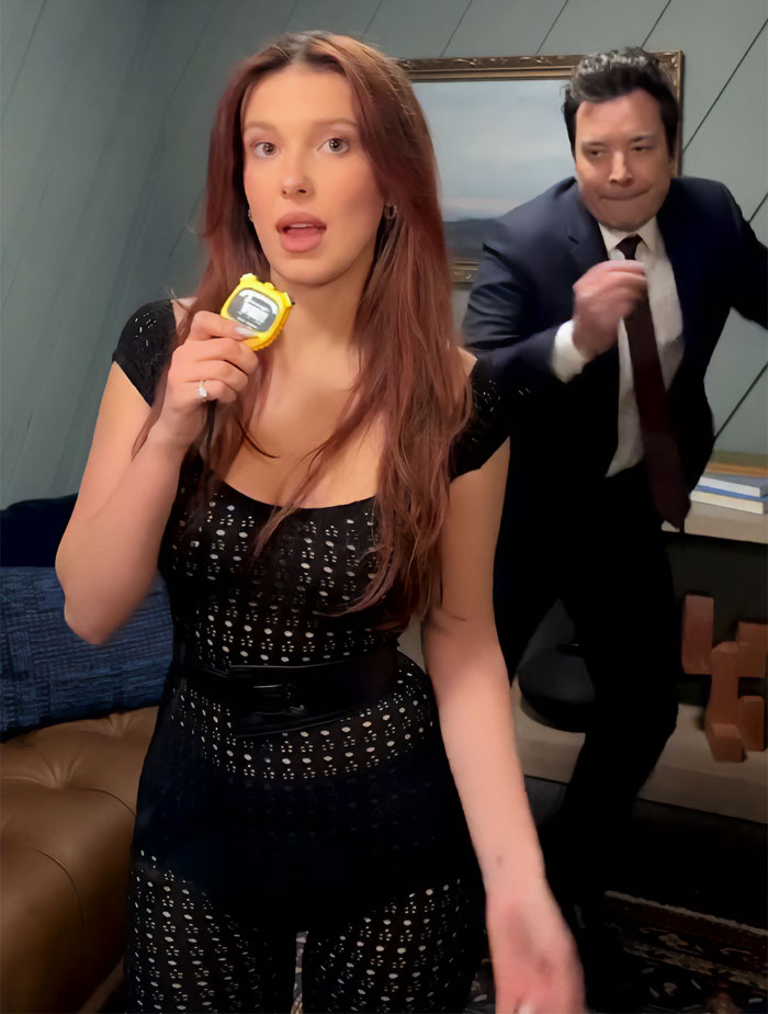 Millie Bobby Brown in a sheer outfit on Fallon set while fans discuss her evolving adult look and past appearances.