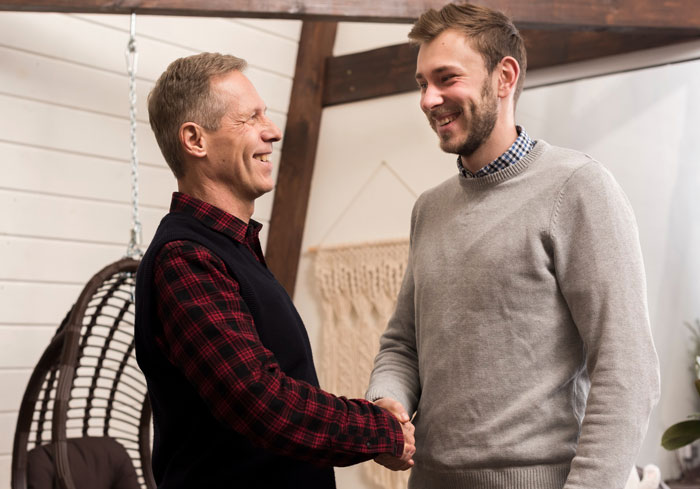 Two men shaking hands indoors, illustrating bride’s parents amid wedding family tensions and confrontations. Two men shaking hands indoors, illustrating bride’s parents amid wedding family tensions and confrontations.