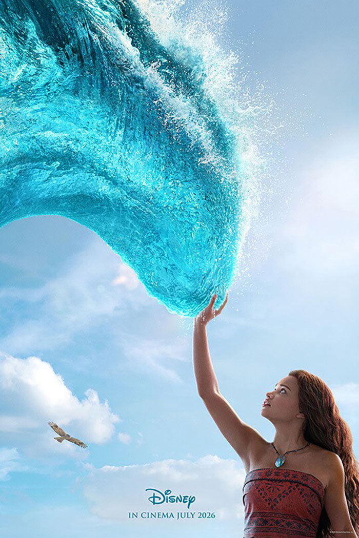 Young woman in tribal dress reaches out to a large wave of water, symbolizing Disney remakes facing criticism and controversies.