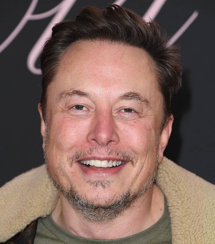 Close-up of a smiling man recognized as one of the most disliked stars of this year in a public event setting.