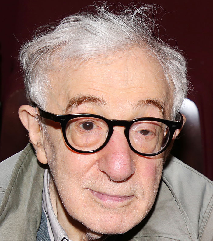 Older man with white hair and black glasses wearing a gray jacket, representing most disliked stars of this year.