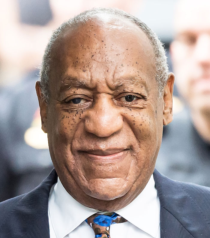 Close-up of an older man in a suit smiling, representing one of the most disliked stars of this year.