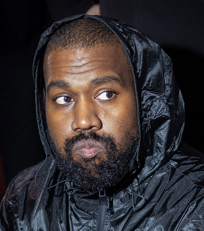 Close-up of a man wearing a black hooded jacket, representing one of the most disliked stars of this year.