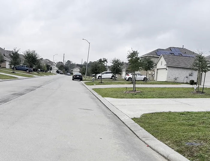 Suburban Texas neighborhood street with houses and cars, related to heroic Texas dad rescuing kidnapped daughter.