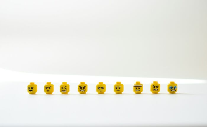 Various LEGO heads with different expressions, illustrating harmless but toxic habits and emotional awareness.