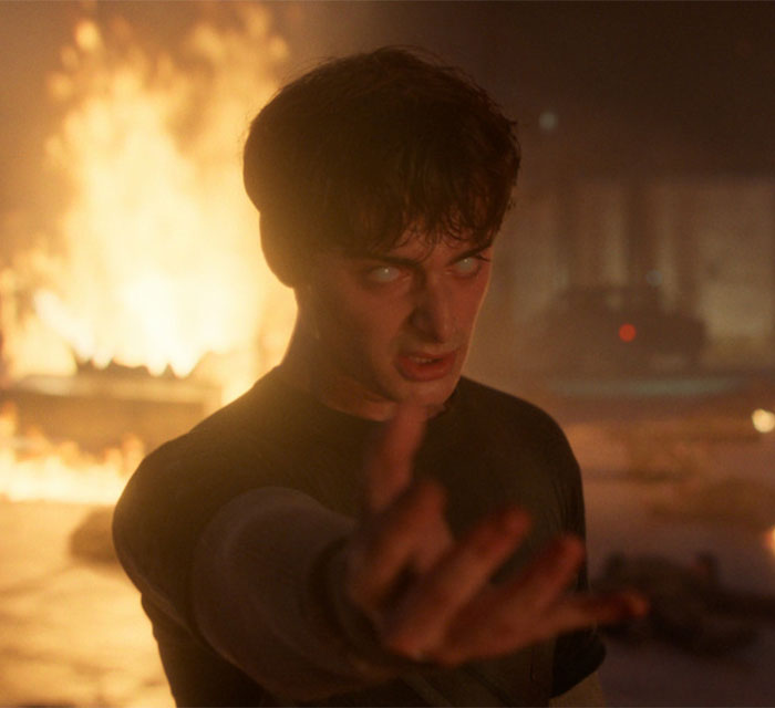 Noah Schnapp acting in intense Stranger Things scene with fiery background during new season performance. Noah Schnapp acting in intense Stranger Things scene with fiery background during new season performance.