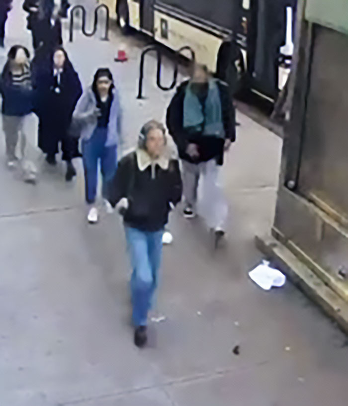 Group of pedestrians walking on a city sidewalk, related to friend of NYU shove victim helping release viral video exposing serial creep.
