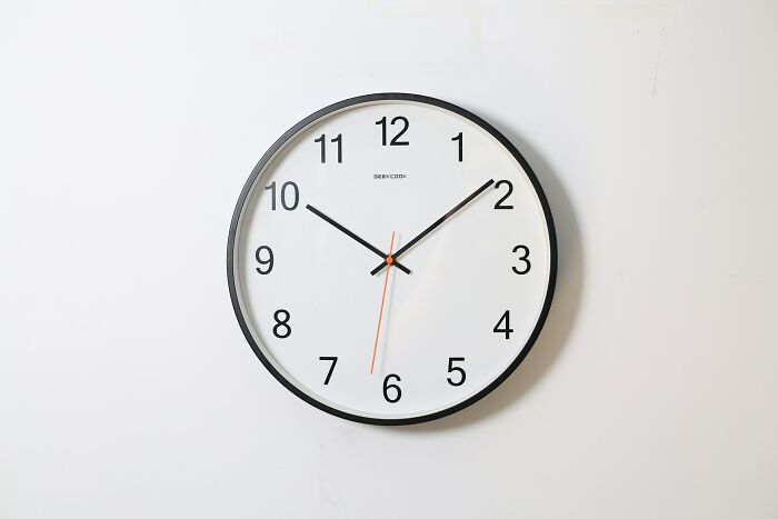 Wall clock with black frame and white face showing time at 10:10, illustrating facts that sound made up but are actually true.