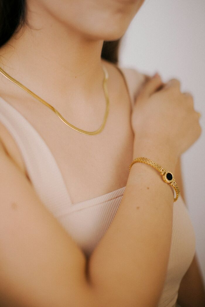 Close-up of unusual personal belongings including gold jewelry lost and found at a public place.