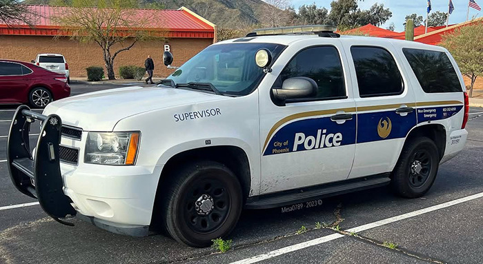 Phoenix police supervisor vehicle parked outside with mountains and buildings in the background during daytime