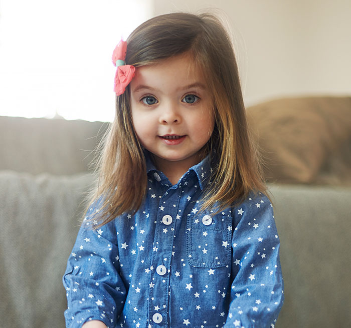 Young girl in a star-patterned shirt, illustrating moments parents realized their kids show selfish and unloving traits.