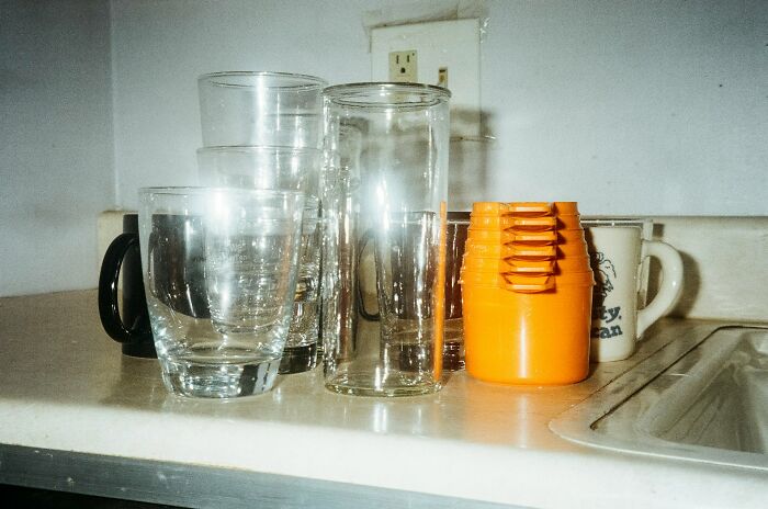 Several everyday kitchen glasses and cups arranged on a counter, illustrating everyday things people accidentally did wrong.