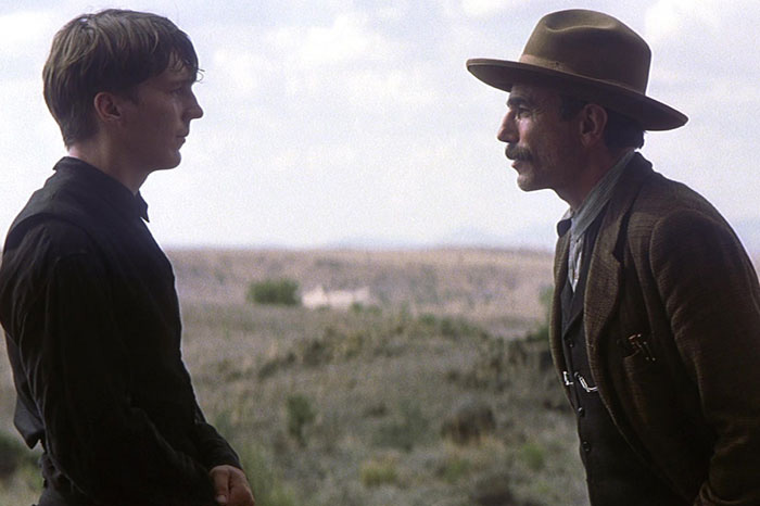 Two men in vintage clothing face each other outdoors, evoking Quentin Tarantino's comments on weakest male actor in Hollywood. Two men in vintage clothing face each other outdoors, evoking Quentin Tarantino's comments on weakest male actor in Hollywood.