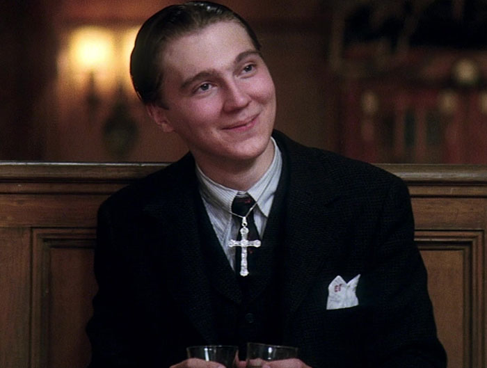 Young male actor in period costume smiling in a dimly lit setting related to Quentin Tarantino controversy news. Young male actor in period costume smiling in a dimly lit setting related to Quentin Tarantino controversy news.