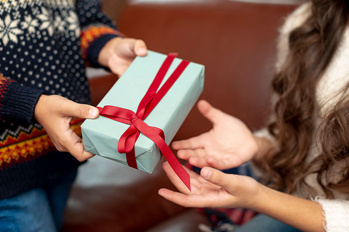 Child handing a wrapped gift to another child, illustrating a legal shortcut to make life easier and feel like a crime.