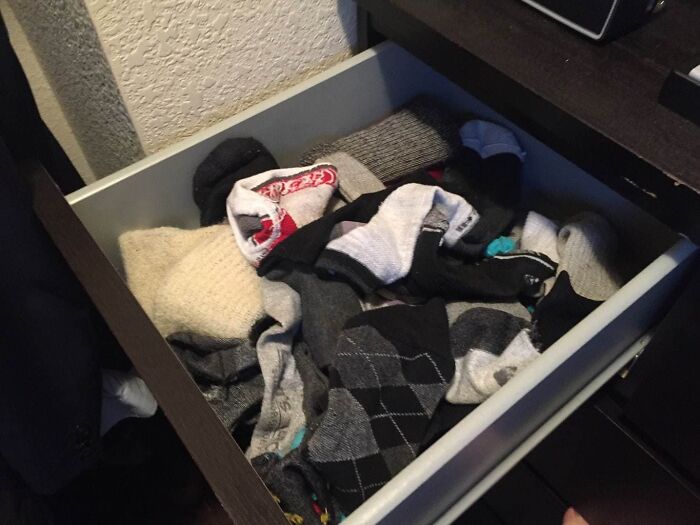 Open drawer filled with mismatched socks, illustrating a terrifying discovery about a partner's messy habits.