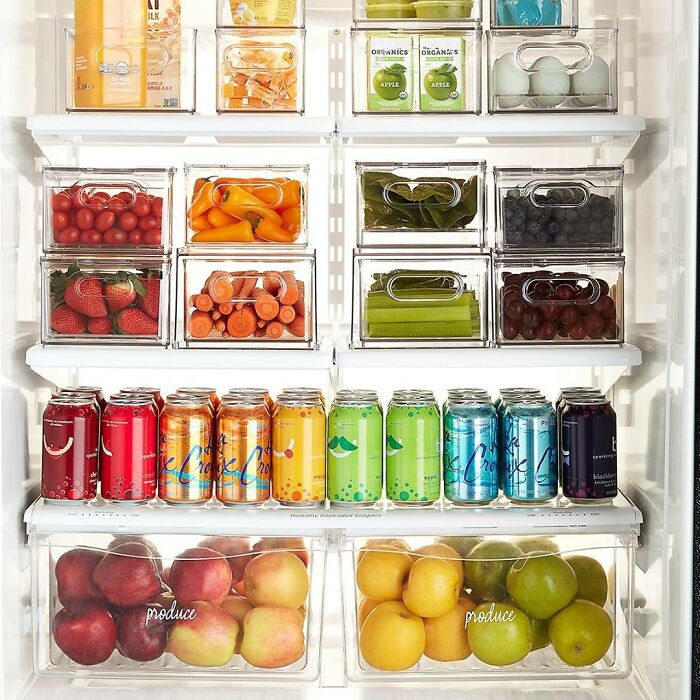 Organized refrigerator with clear containers holding fresh produce and drinks, illustrating surprising partner habits revealed.