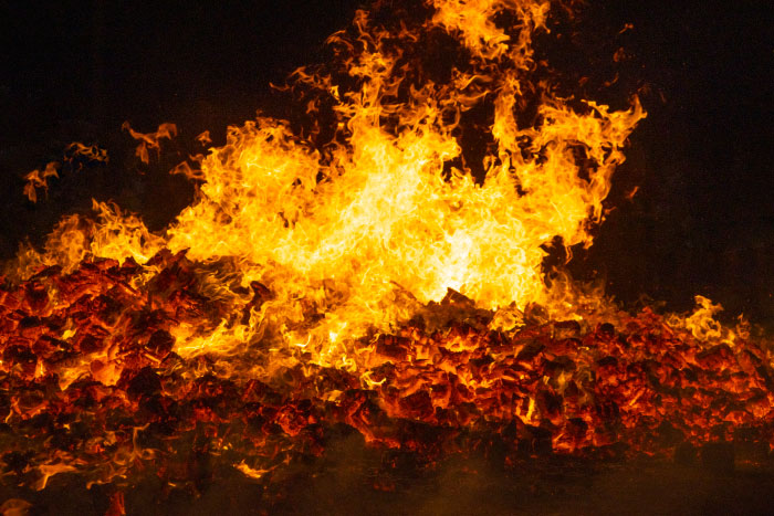 Large intense fire burning bright flames with glowing embers, representing scary moments that left people traumatized.