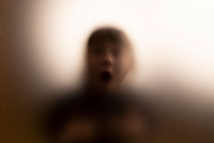 Blurred image of a person with a scared expression, representing scary moments that left them traumatized.