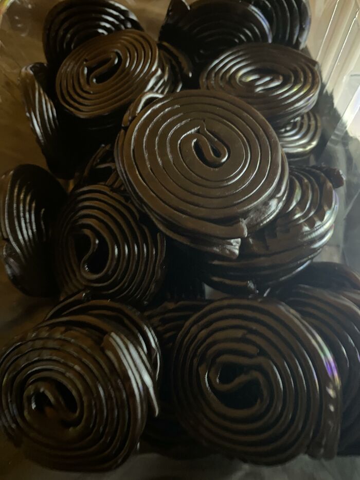 Close-up of black licorice spirals stacked together, illustrating wild patient confessions doctors have heard.
