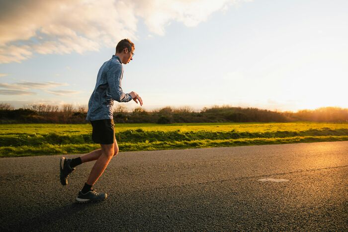 Man running on empty road at sunset, captured in a moment that feels so scary people still talk about it.