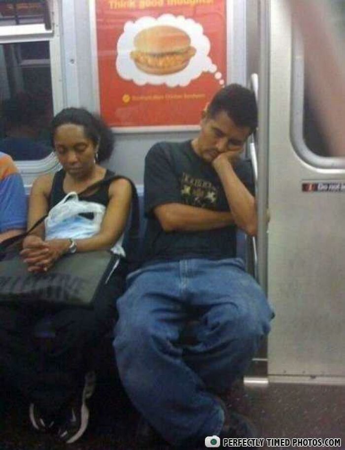 Two passengers sleeping on a subway bench beneath a perfectly timed advertisement with a food image.