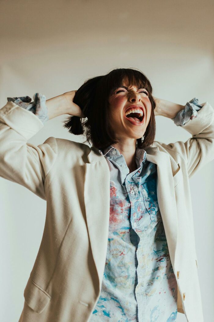 Young woman expressing excitement and surprise, conveying emotions found in crazy airport stories and unbelievable moments.