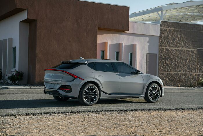 Modern silver SUV parked beside a building illustrating small design mistakes impacting overall aesthetics and functionality.