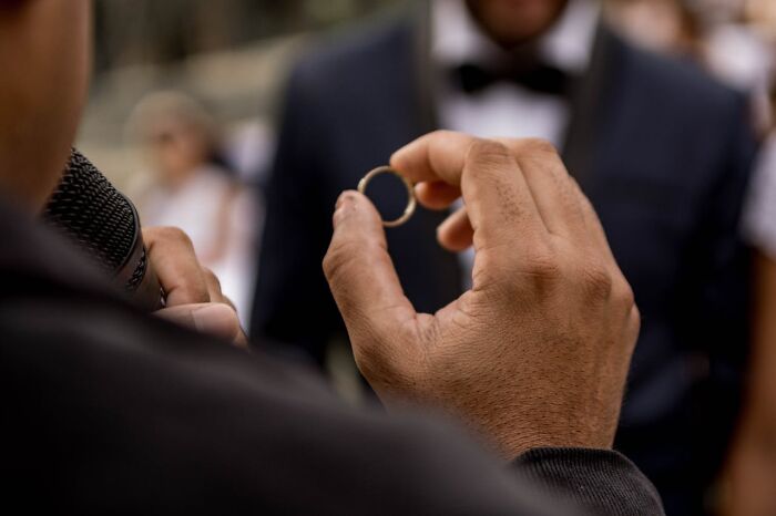 Close-up of a hand holding a ring, representing unusual personal belongings never claimed at a lost and found.