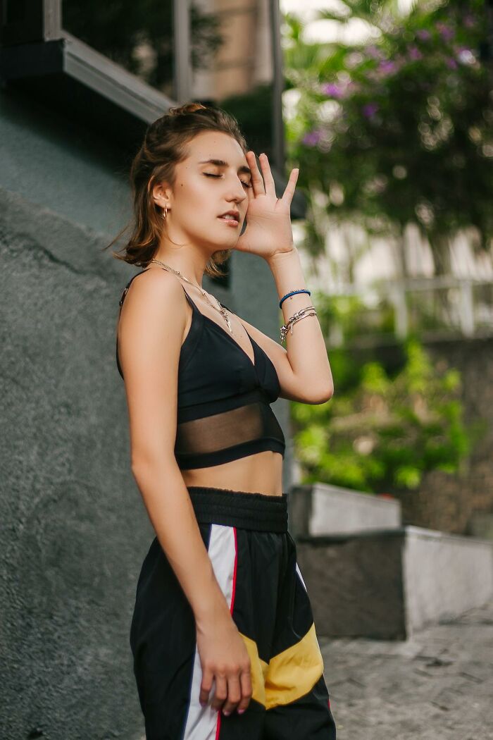 Young woman in sporty outfit posing outdoors, reflecting on disturbing facts people learned against their will.