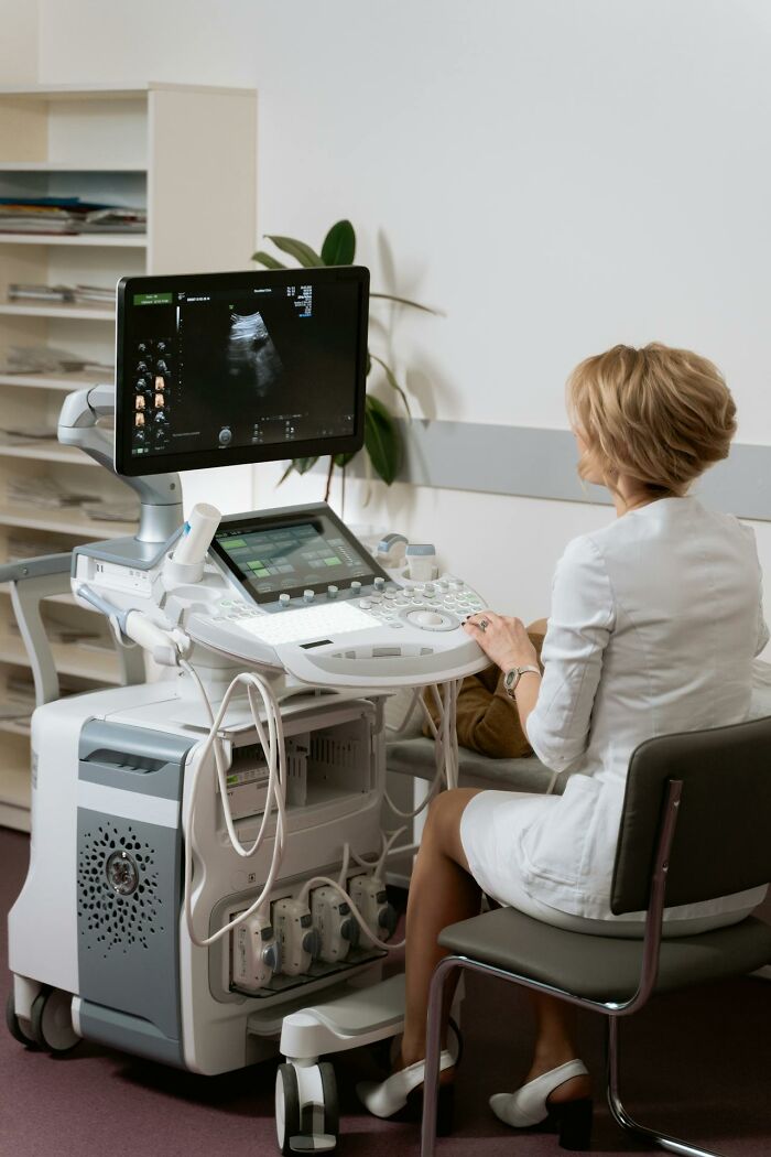 Medical professional using ultrasound machine in clinic, highlighting disturbing truths in health information research.