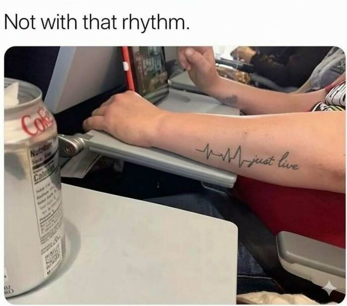 Arm with a heartbeat tattoo that says just live, shown with a laptop and soda can, highlighting hilarious memes about stress relief.