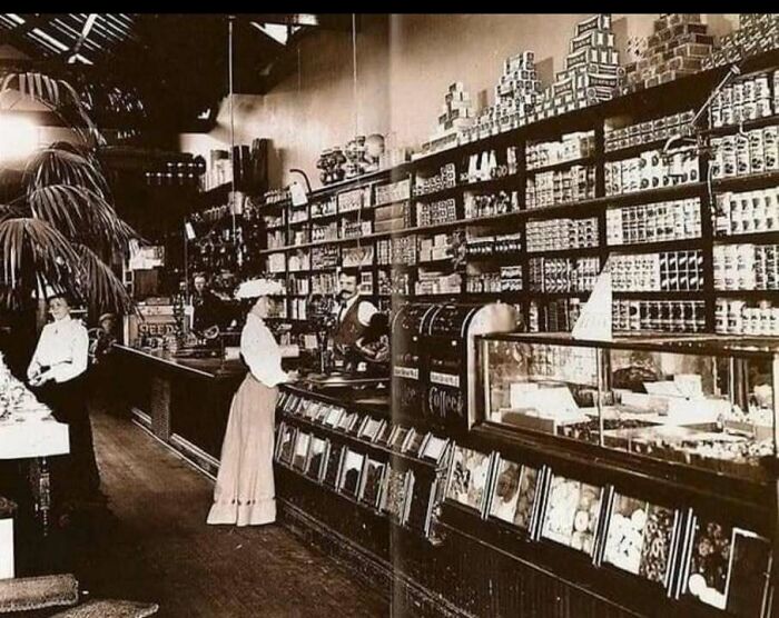 Vintage black and white photo of an iconic historical store interior with people shopping and classic product displays.