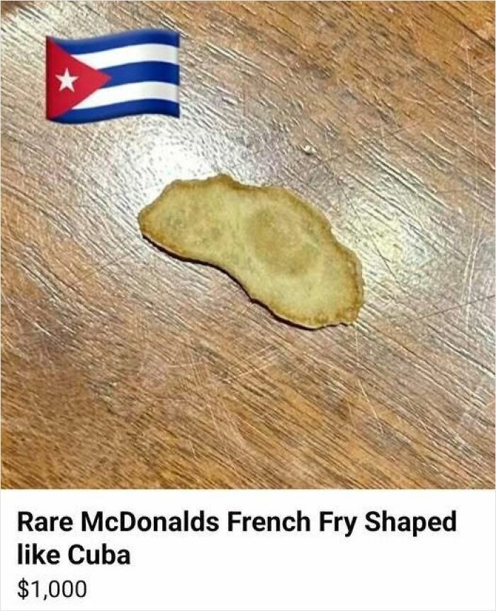 Rare McDonalds French fry shaped like Cuba on wooden surface, a funny random pic that makes you laugh before you know why.