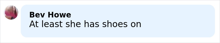 Brooks Nader wearing a red Santa belt styled as a shirt, posing outdoors in a snowy Aspen setting.