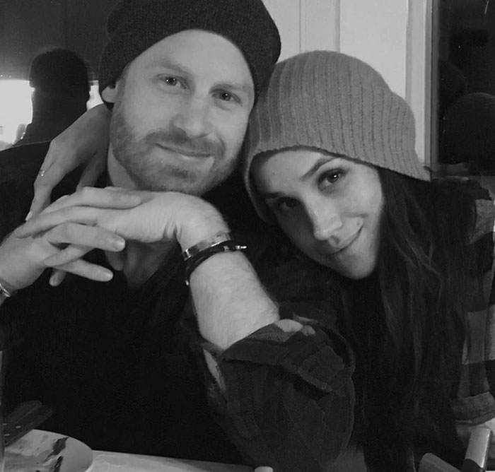 Prince Harry and Meghan Markle in a casual setting wearing beanies, reflecting on PR gurus revealing why ties were cut.