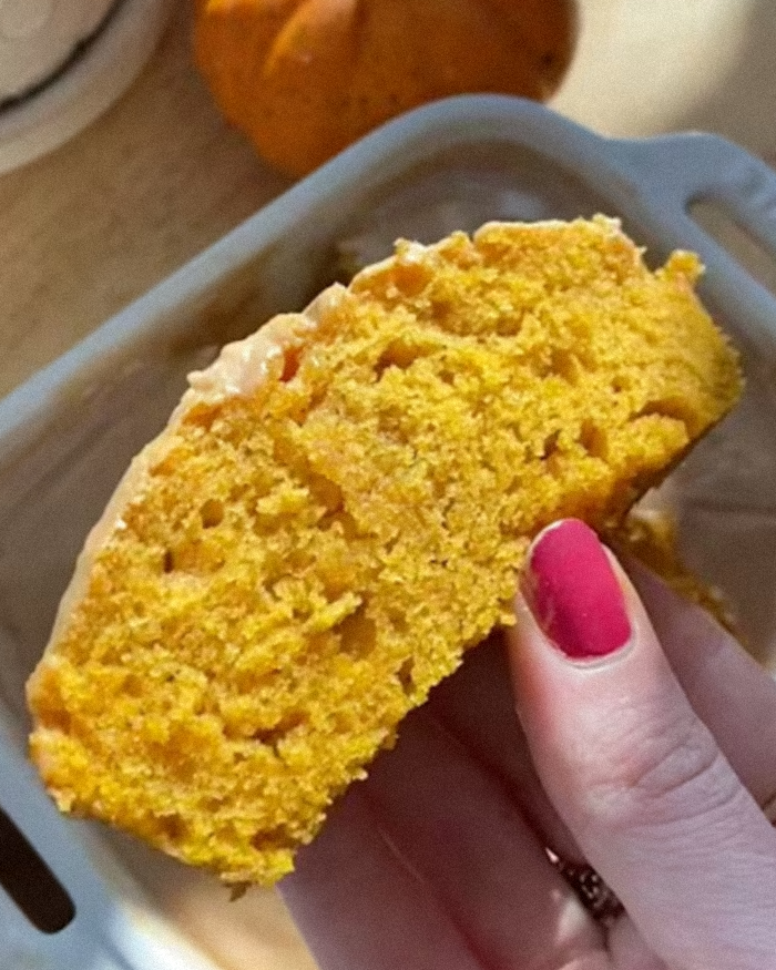 Hand holding a slice of orange pumpkin bread, highlighting the decolonized Christmas recipe by a woke social media user. Hand holding a slice of orange pumpkin bread, highlighting the decolonized Christmas recipe by a woke social media user.