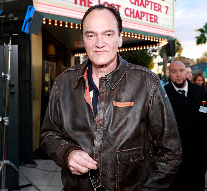 Quentin Tarantino wearing a leather jacket at a film premiere, related to weakest male actor controversy in Hollywood. Quentin Tarantino wearing a leather jacket at a film premiere, related to weakest male actor controversy in Hollywood.