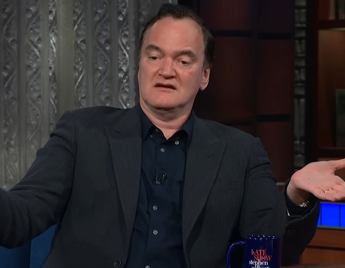 Quentin Tarantino speaking on a talk show, discussing weakest male actor controversy in Hollywood industry. Quentin Tarantino speaking on a talk show, discussing weakest male actor controversy in Hollywood industry.